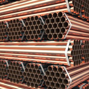 Copper or bronze metal pipes in warehouse. Heavy non-ferrous metallurgical industry.